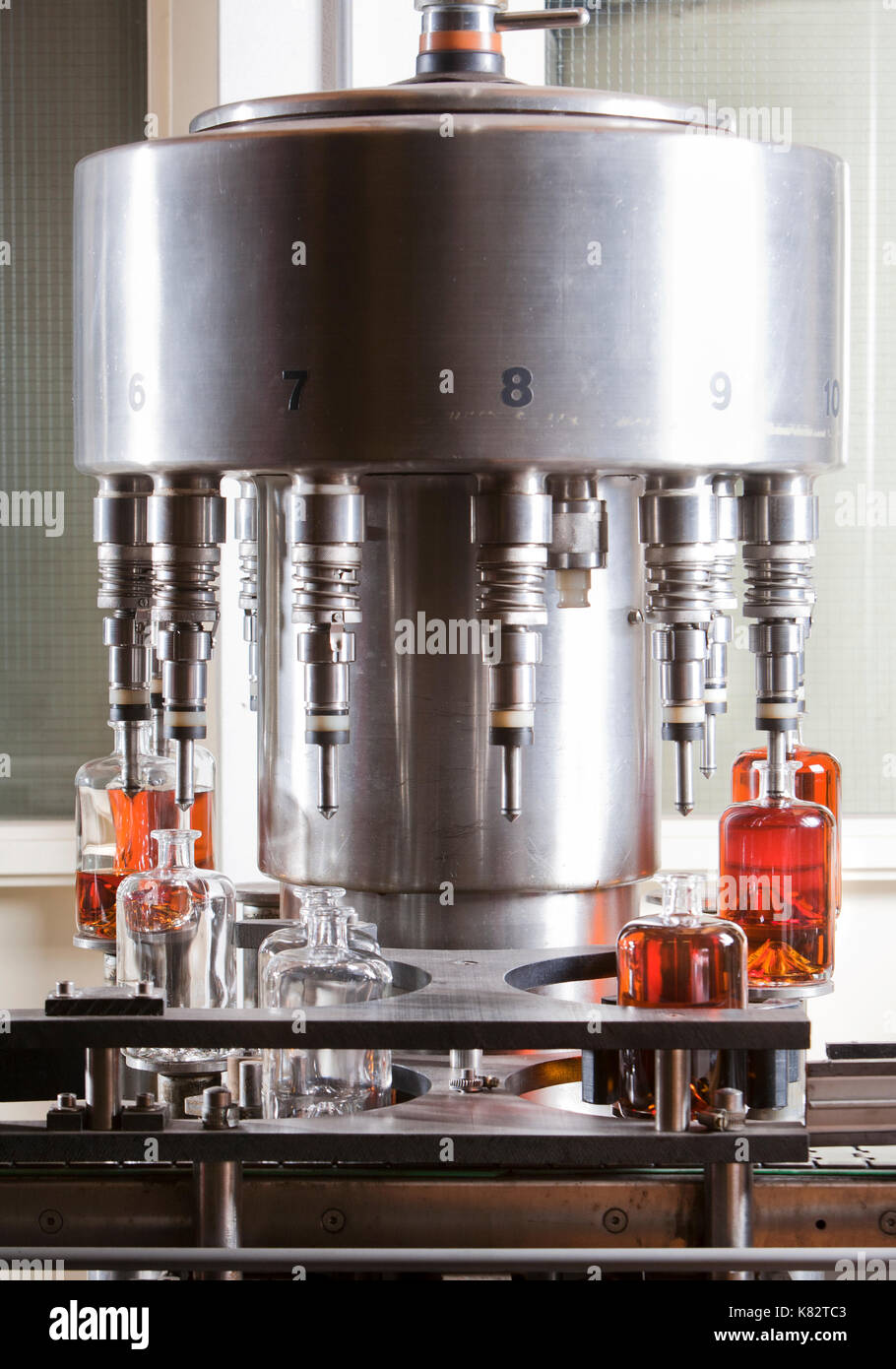 Bottle filling machine filling the bottles with liquor Stock Photo