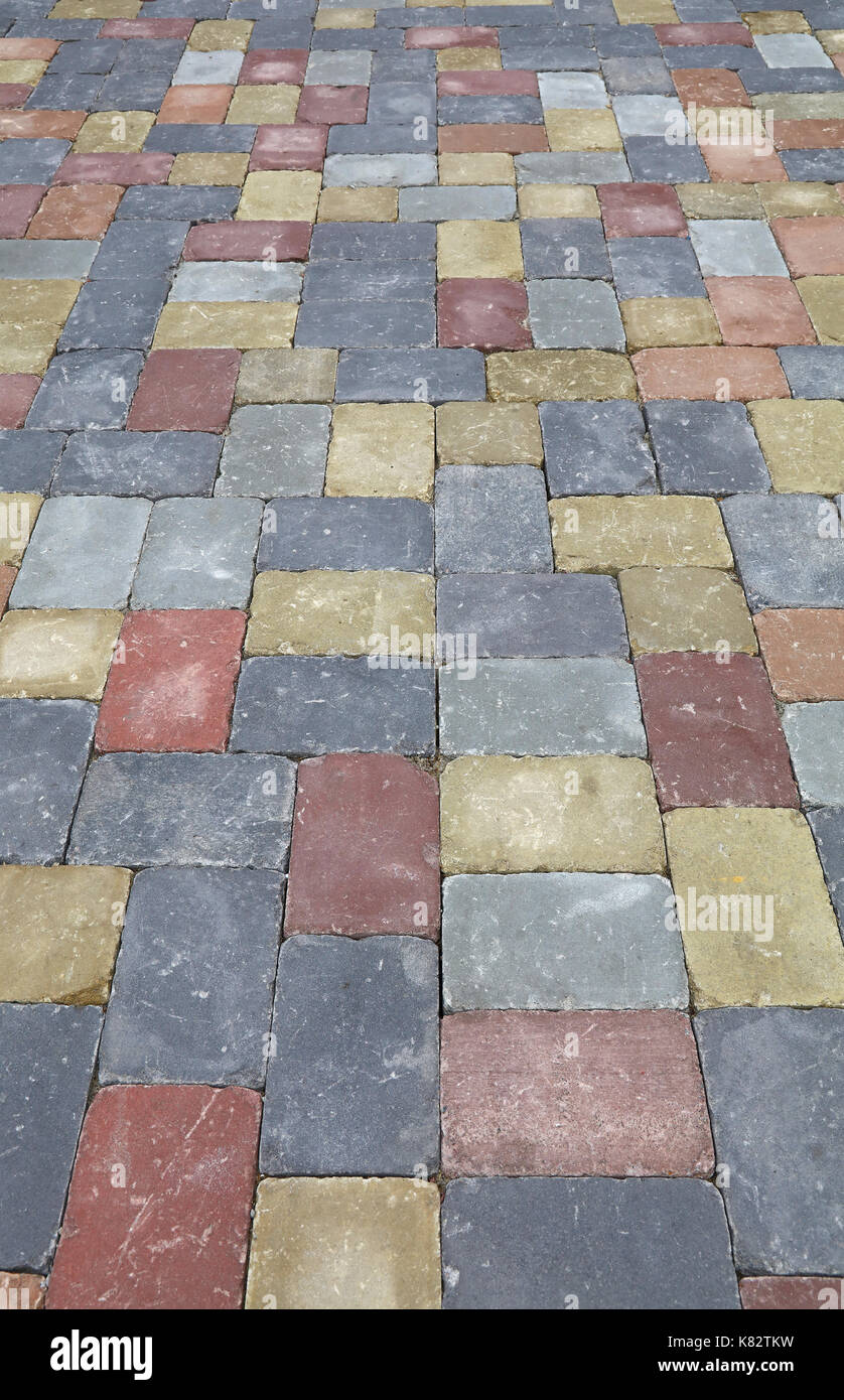 Background of street road colorful stone paving of multicolor bricks, close up, high angle view Stock Photo