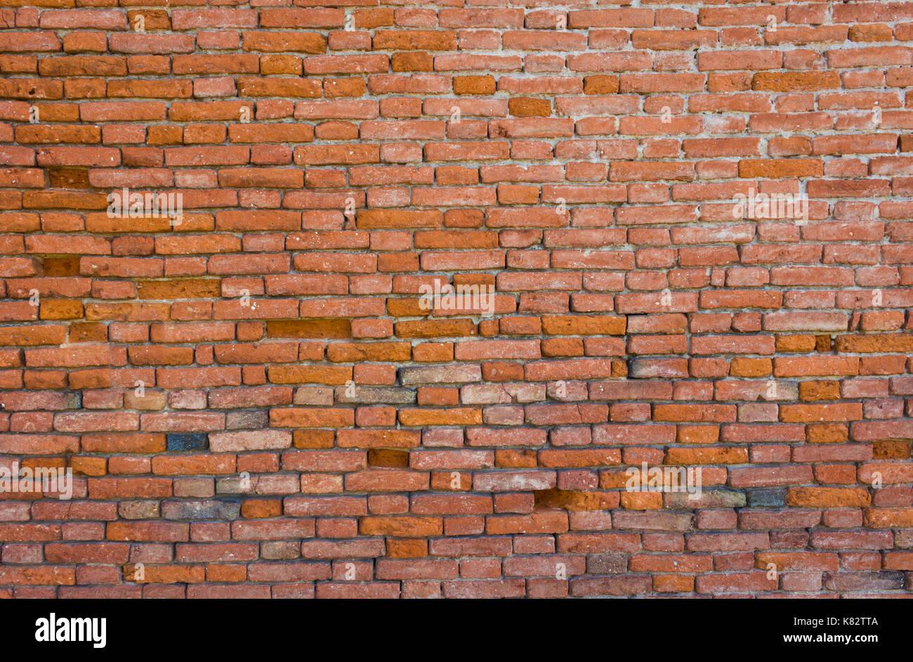 Old brick wall, old texture of red stone blocks closeup Stock Photo
