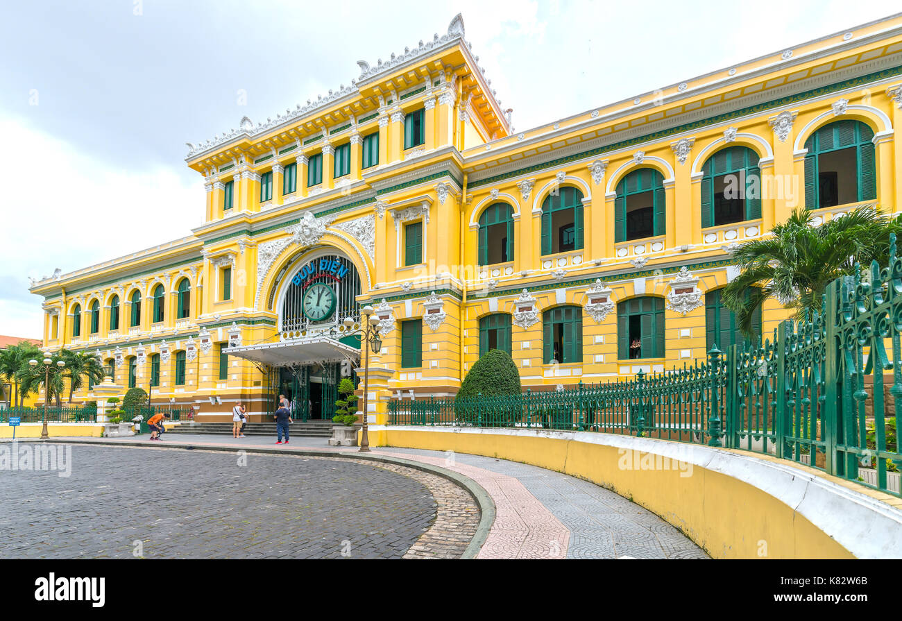 Tourists visit outside Saigon Central Post Office Architecture. It was built by the French in 1886 and is a popular attraction Stock Photo
