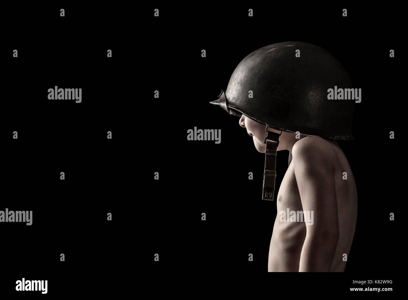 portrait of child soldier on black background Stock Photo