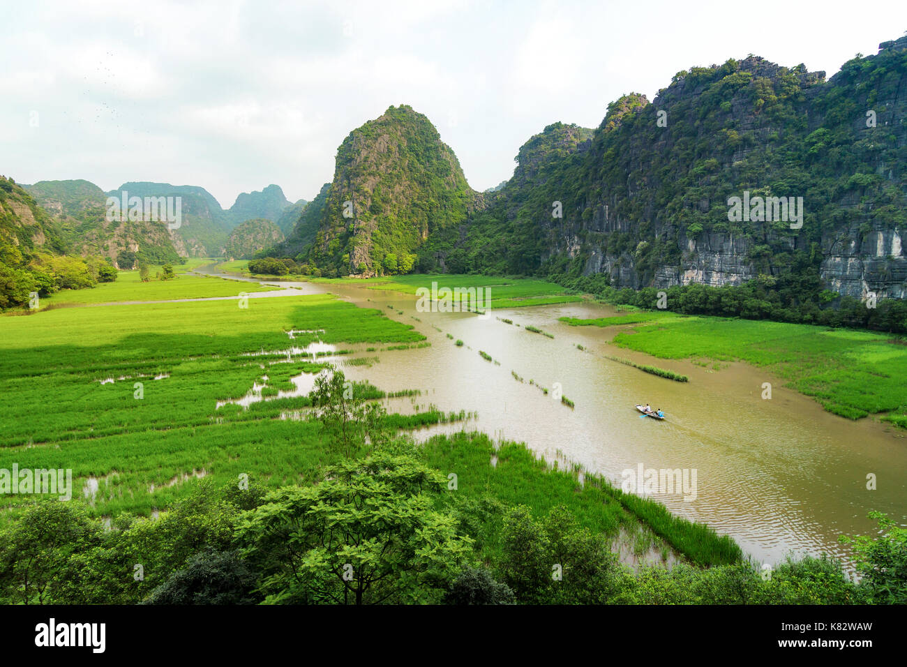 The Ngo Dong River, near Tam Coc village, at the Trang An UNESCO World Heritage site in Ninh Binh, Vietnam. Stock Photo