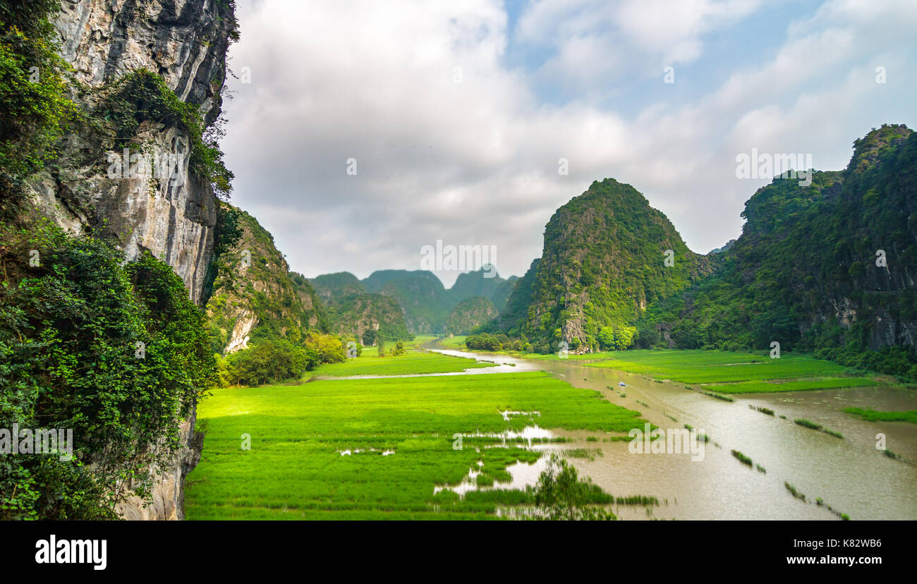 The Ngo Dong River, near Tam Coc village, at the Trang An UNESCO World Heritage site in Ninh Binh, Vietnam. Stock Photo