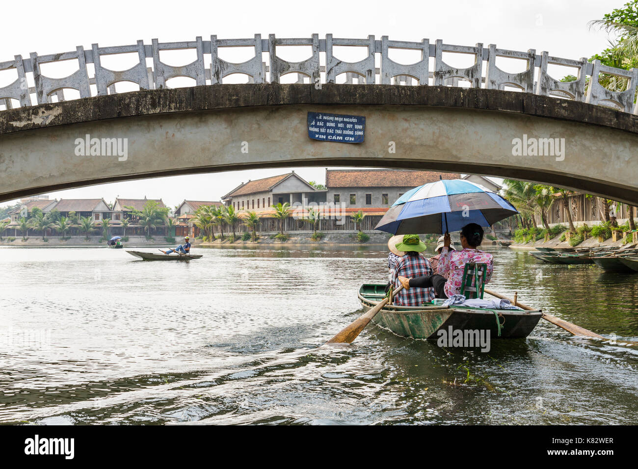 NINH BINH, VIETNAM - 5/6/2016: Boats on the Ngo Dong River, entering Tam Coc village, at the Trang An UNESCO World Heritage site in Ninh Binh, Vietnam Stock Photo