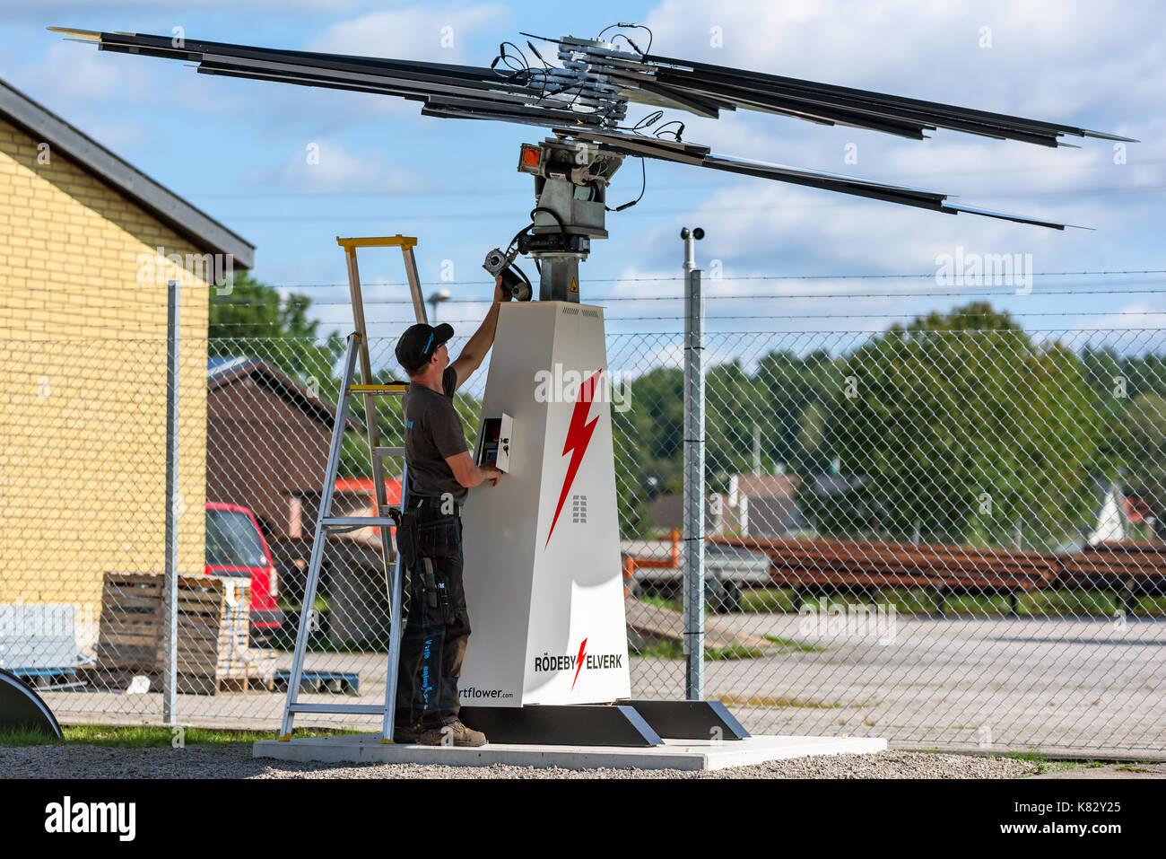 Karlskrona, Sweden - August 28, 2017: Real life documentary of technician working on Smartflower sun tracking solar power station, fans lifted for acc Stock Photo