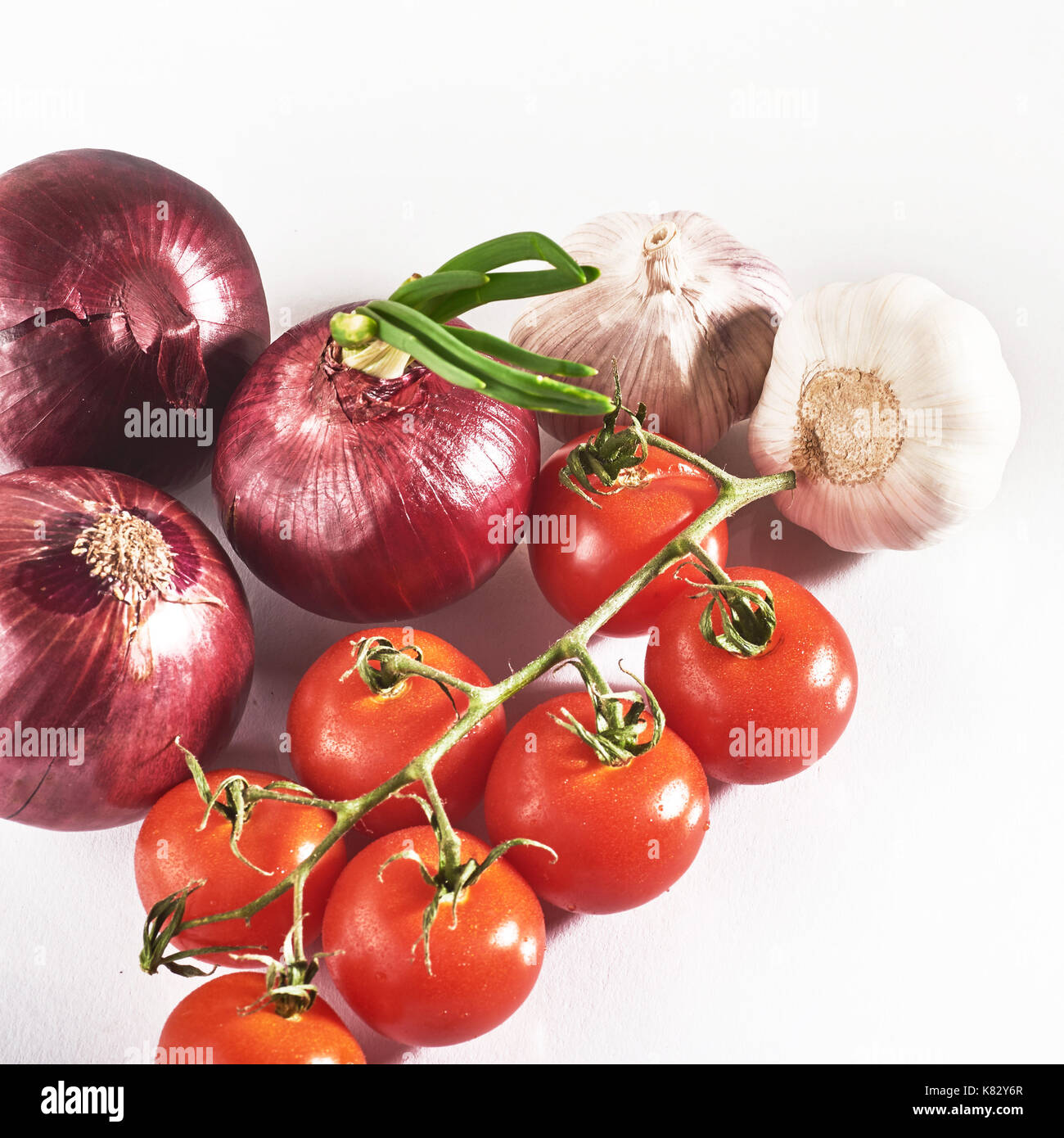 blue onion garlic and tomato isolated on white background Stock Photo ...