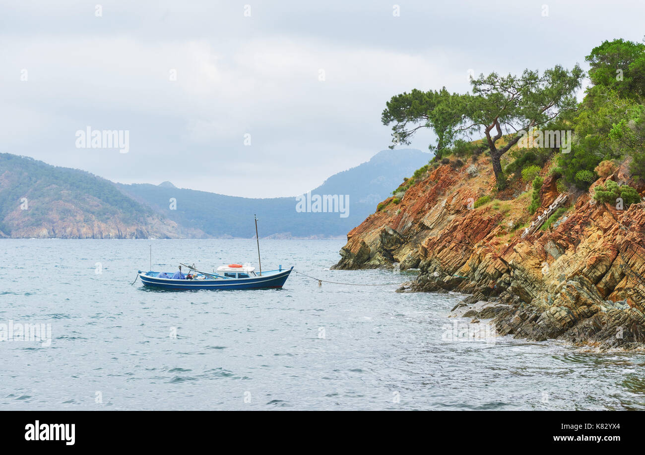 Boats sailing in a calm blue sea water near mountains in Turkey Stock ...