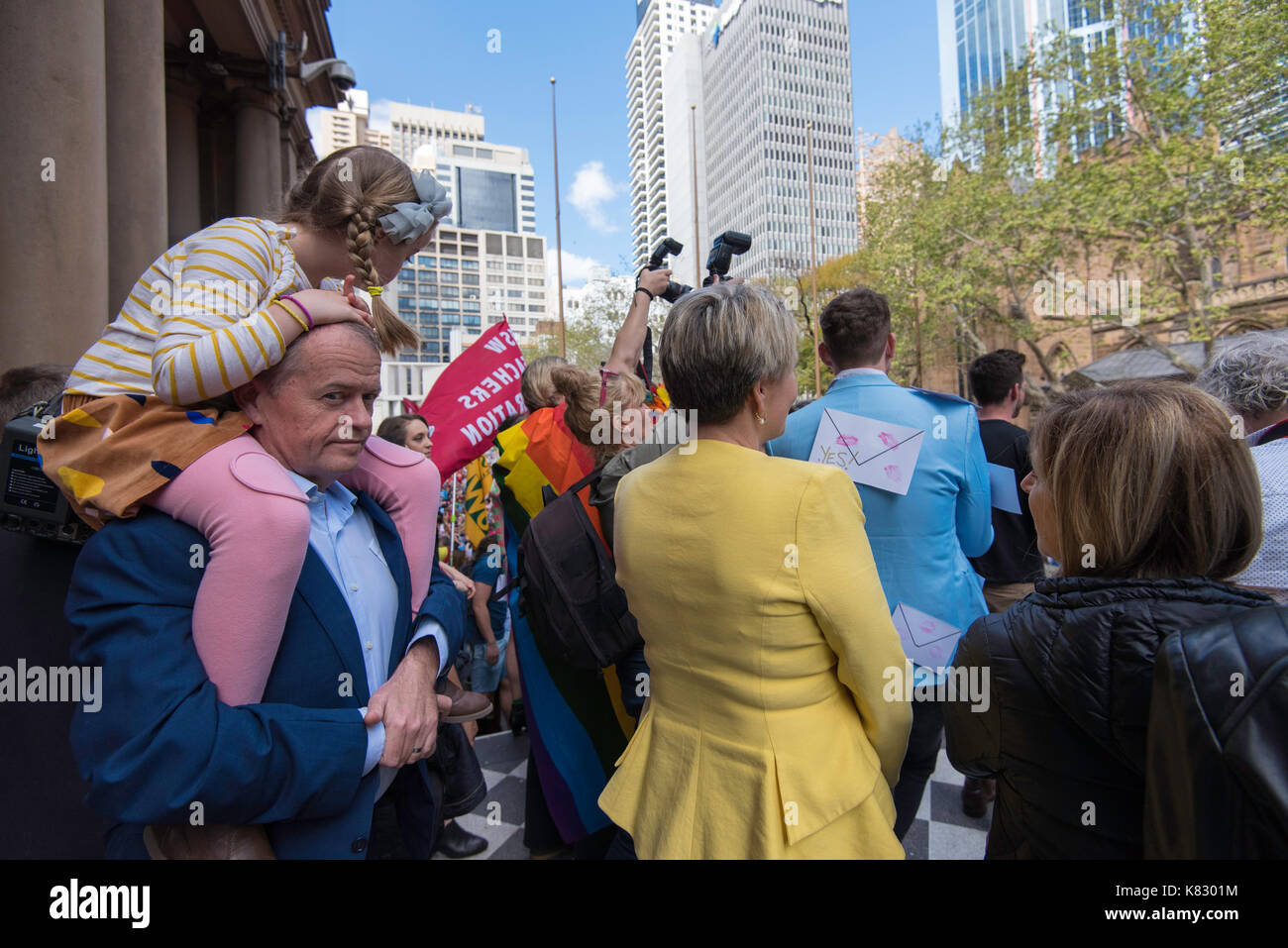 Federal Opposition Leader Mr Bill Shorten with daughter on his shoulders waits behind his deputy Tania Plebisec to speak at a marriage equality rally Stock Photo