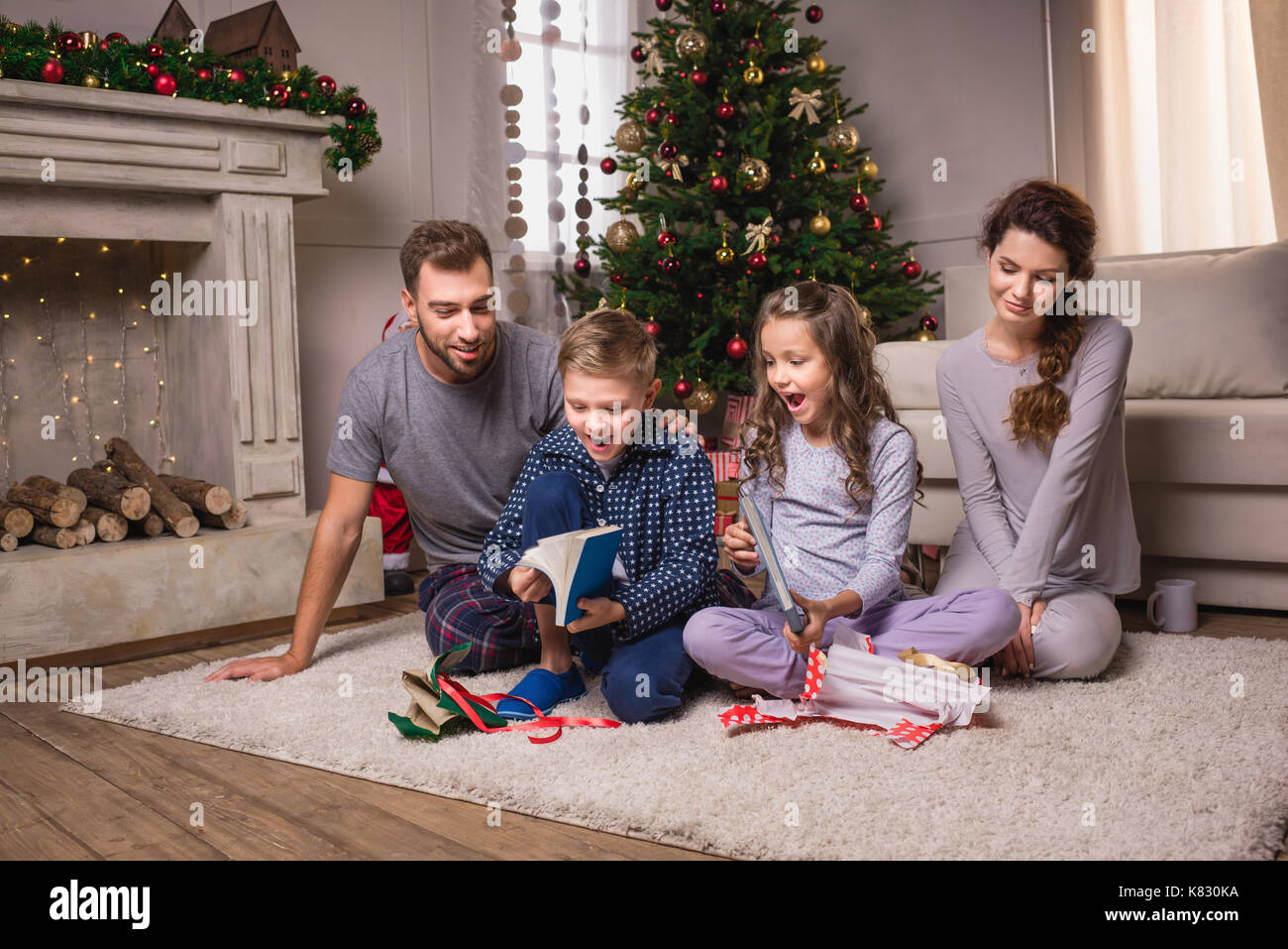 family opening presents on christmas eve Stock Photo