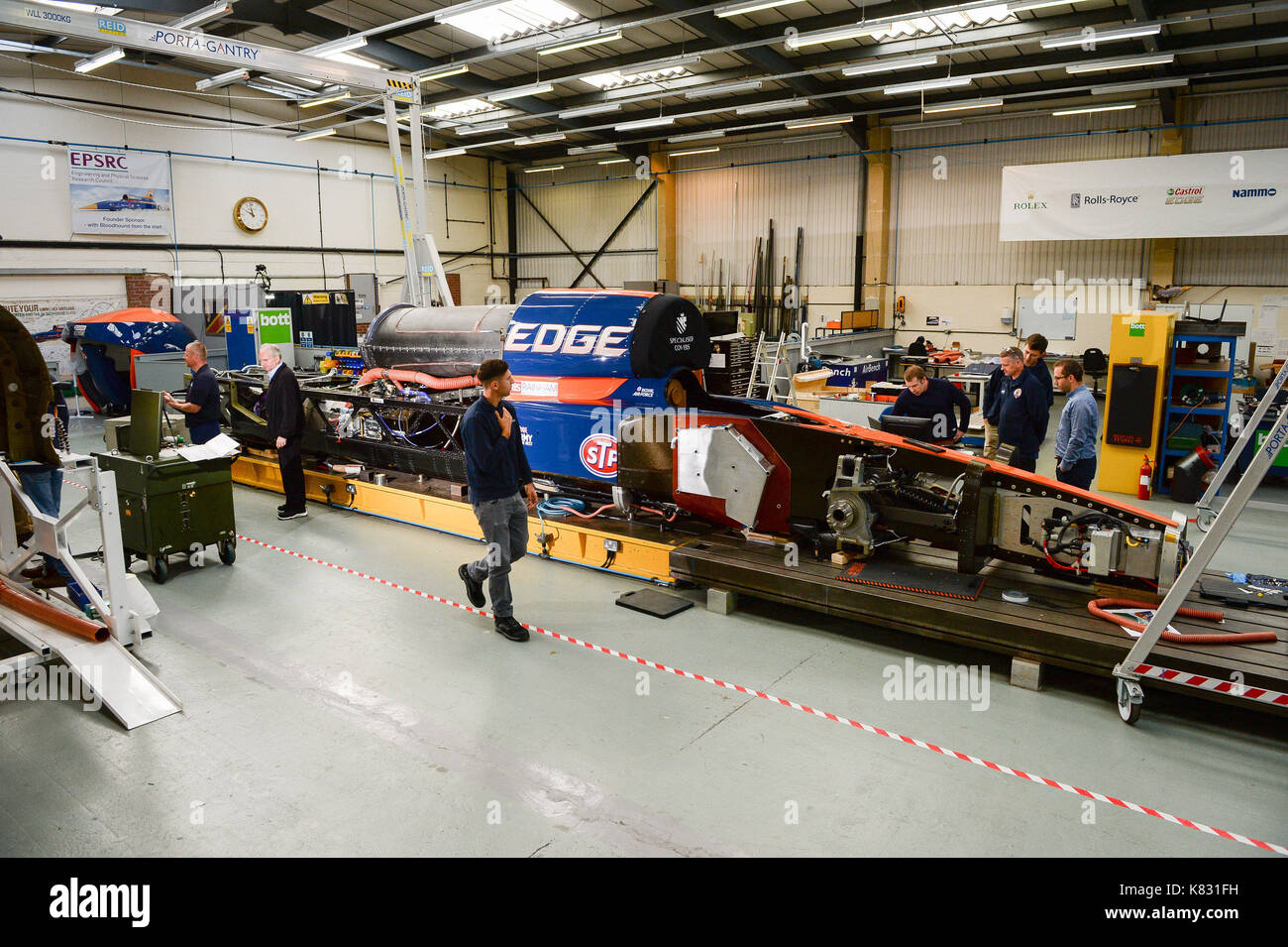 Engineers work on the lower chassis in preparation for mounting the upper chassis, which houses the jet engine, at the Bloodhound Technical Centre in Avonmouth, as the BLOODHOUND SSC car is prepared for testing in Newquay in October. Stock Photo