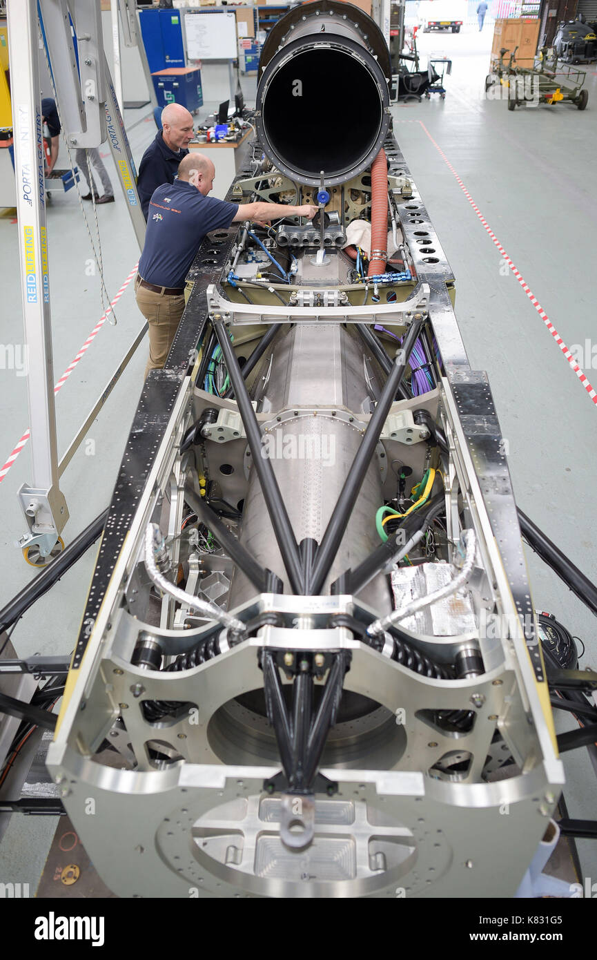 Engineers work on the lower chassis in preparation for mounting the upper chassis, which houses the jet engine, at the Bloodhound Technical Centre in Avonmouth, as the BLOODHOUND SSC car is prepared for testing in Newquay in October. Stock Photo