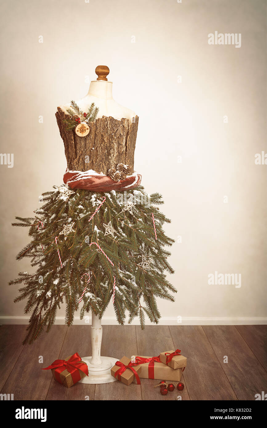 Mannequin dressed for Christmas with pine branches Stock Photo