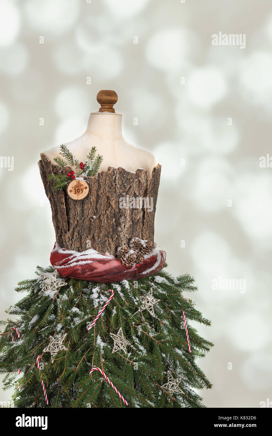 Mannequin dressed for Christmas with pine branches Stock Photo