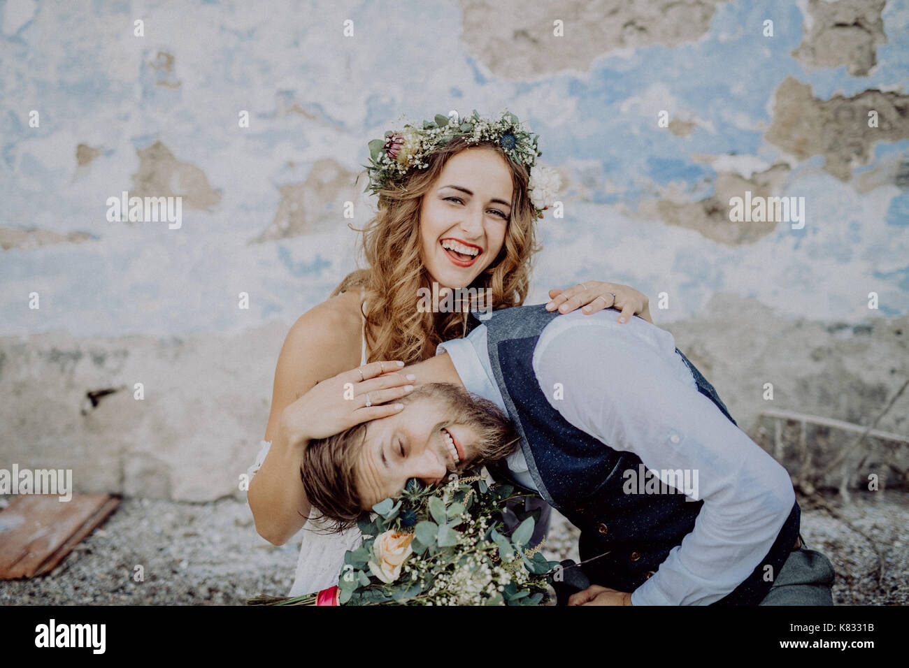 Beautiful bride and groom in front of old shabby house Stock Photo - Alamy