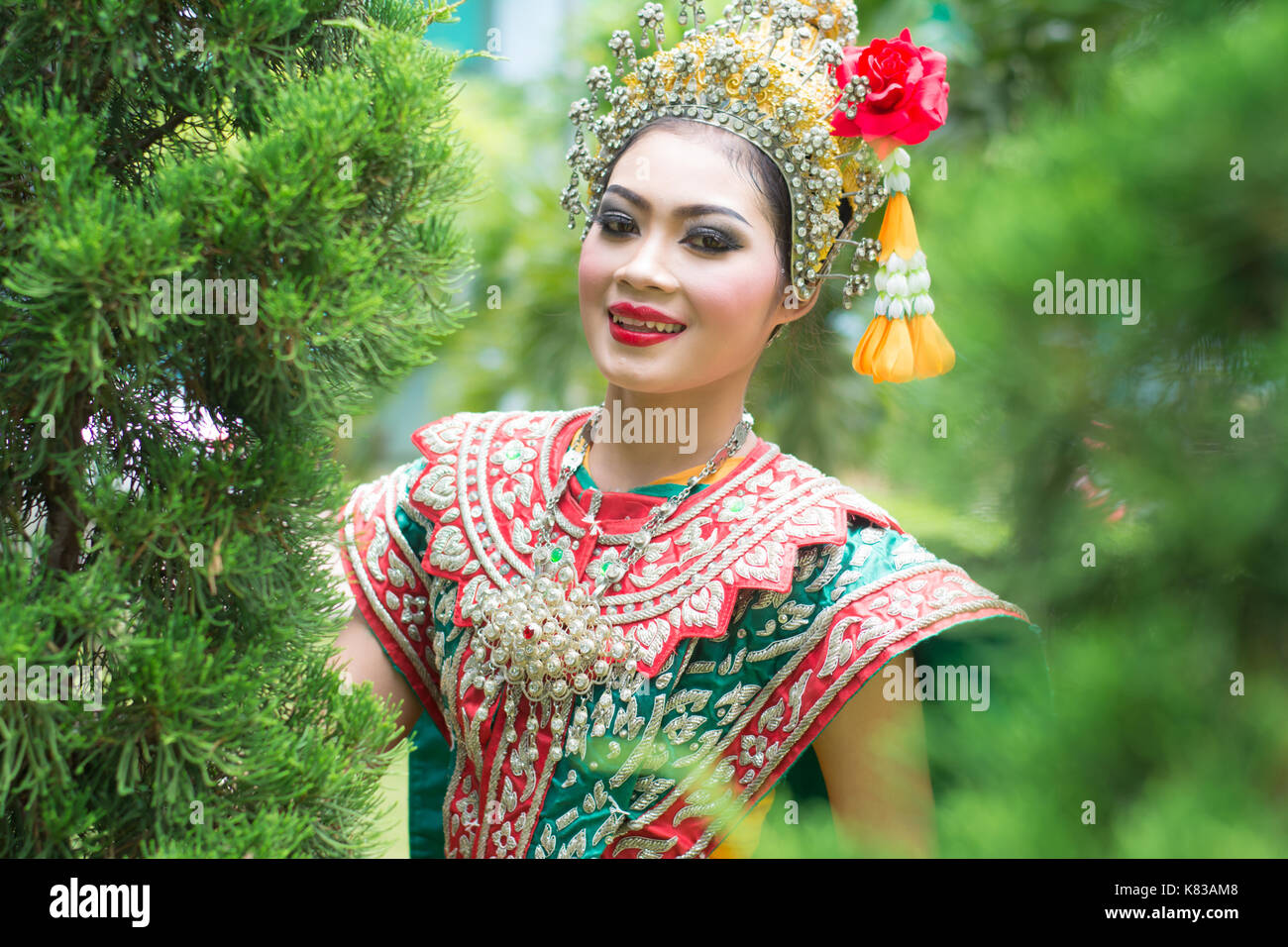 Portrait of Thai young lady wearing Thai traditional dress in the garden Stock Photo