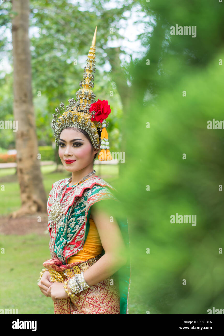 Portrait of Thai young lady wearing Thai traditional dress in the garden Stock Photo