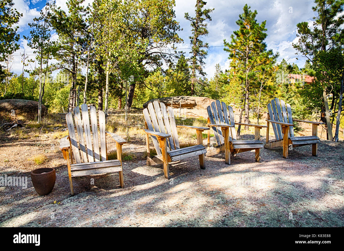 Adirondack Chairs Arainged On A Rock Overlooking A Mountain
