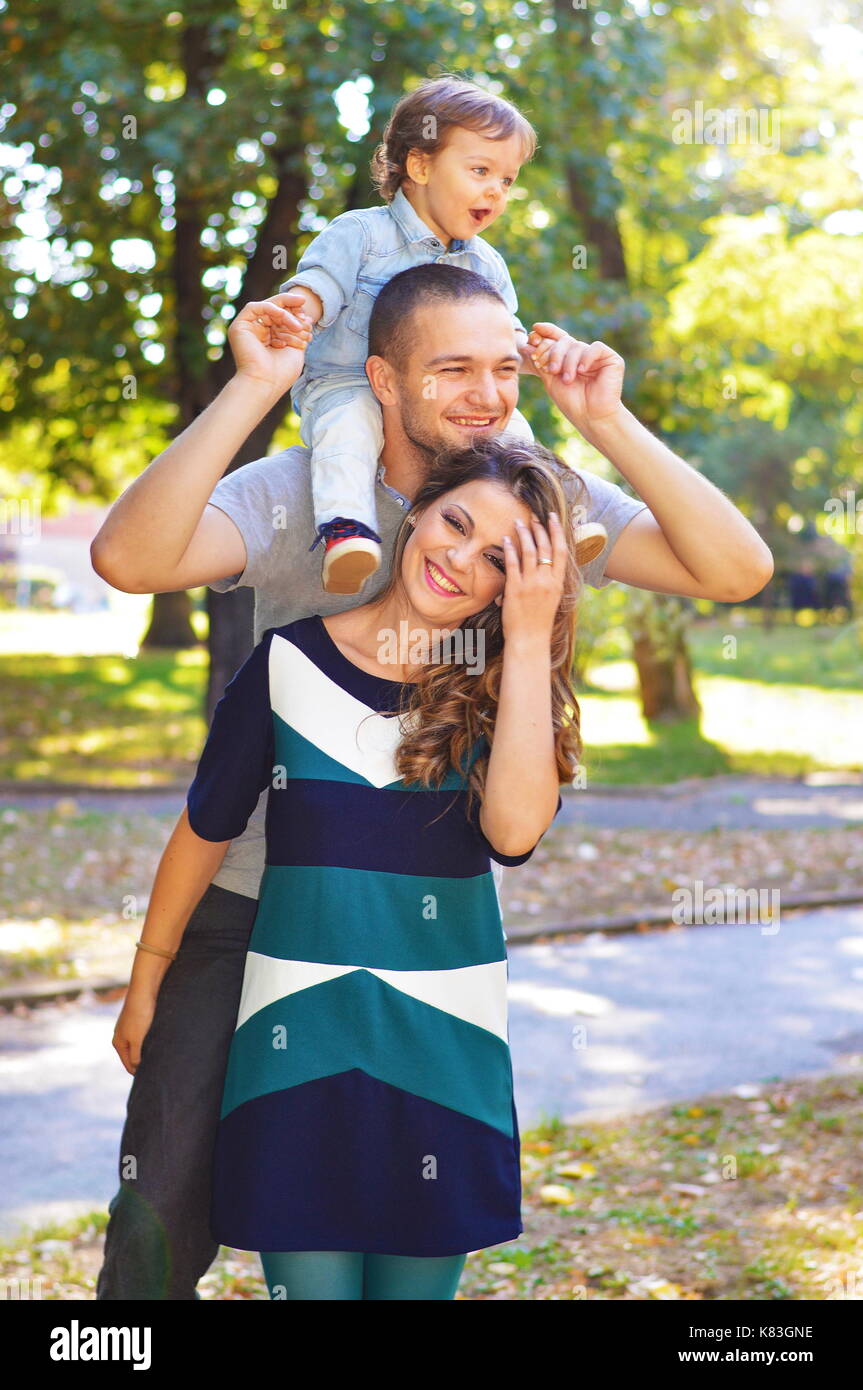 Beautiful and young happy family in the park Stock Photo