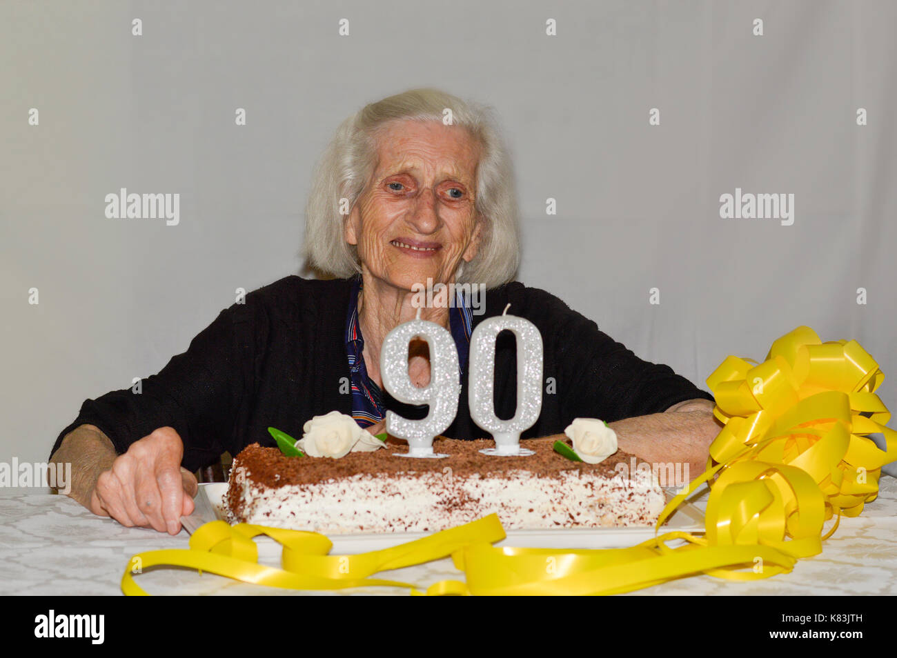 Mixed feelings of a grandma celebrating her 90th birthday Stock Photo - Ala...