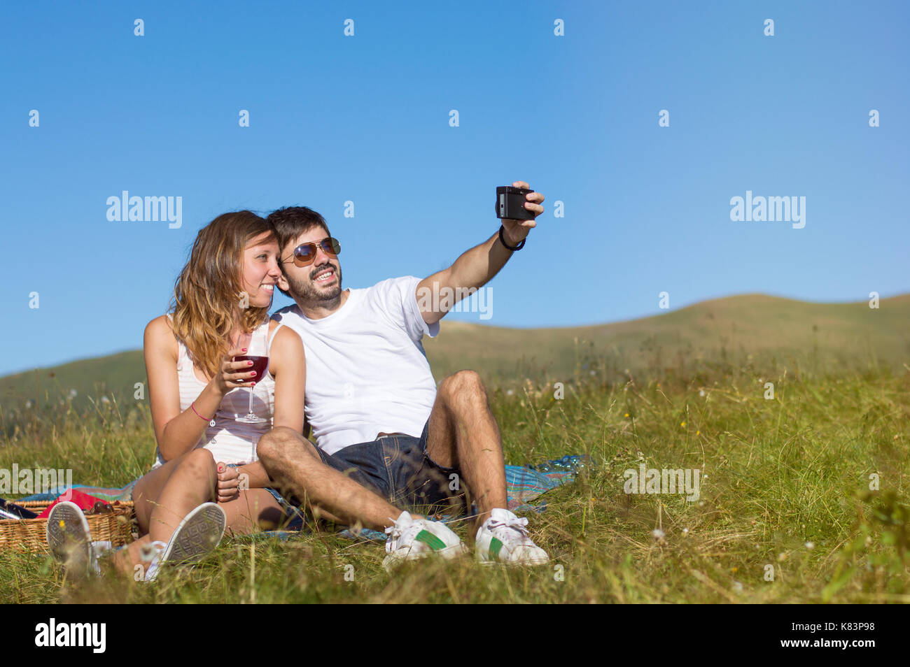 Couple of hikers making selfie with a retro camera  while on pause while hiking Stock Photo