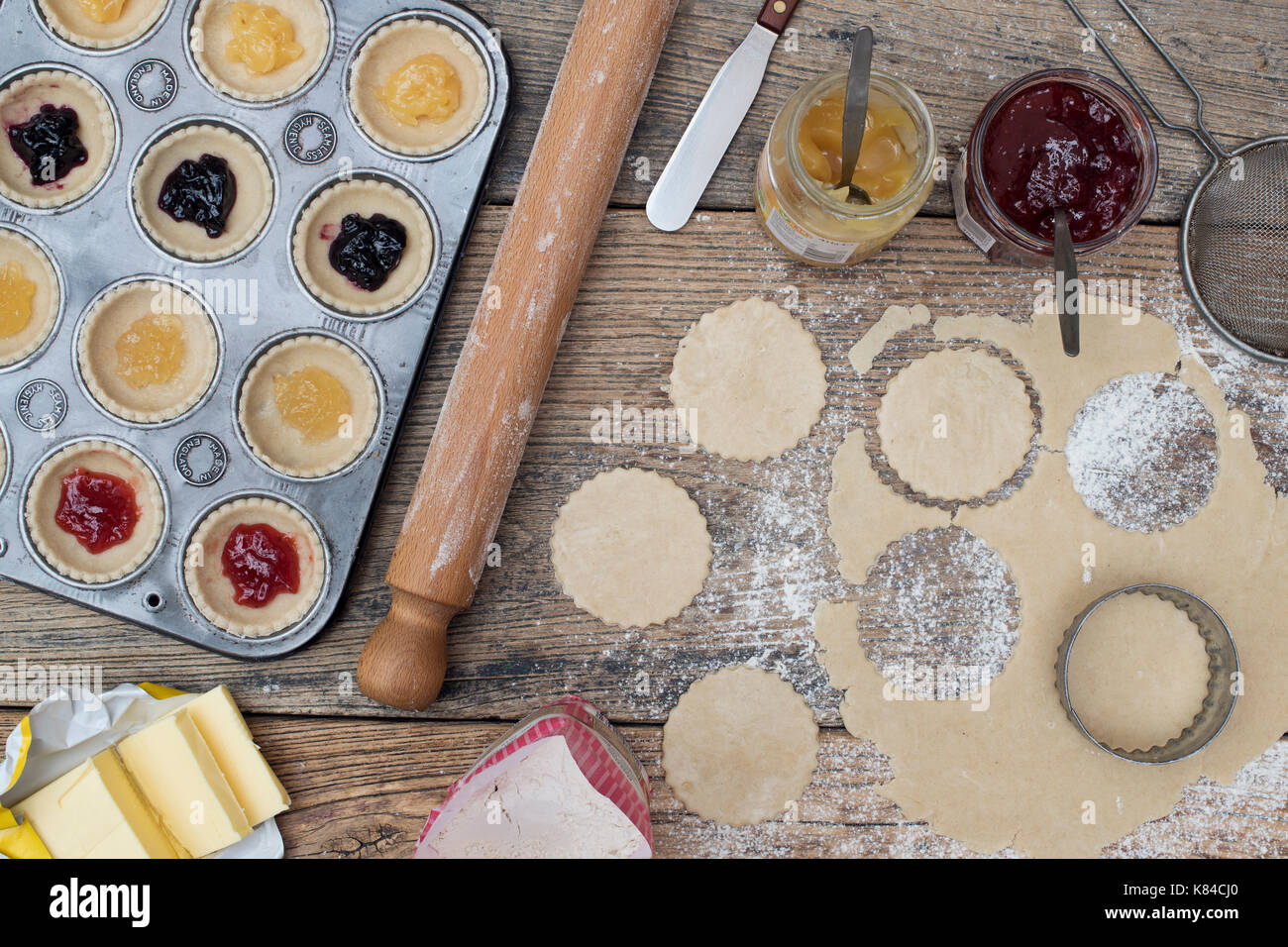 Making and baking homemade jam tarts. Pattern from above Stock Photo