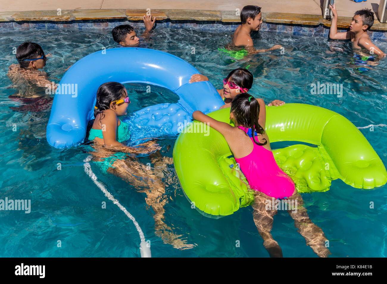girls and boys, children, swimmers, swimming, swimming pool, freshwater swimming pool, pool party, Castro Valley, Alameda County, California, United Stock Photo