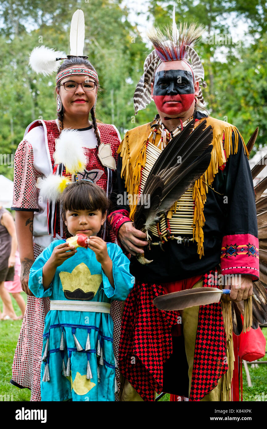 Canada indigenous, Canadian First Nations family posing for a portrait wearing aboriginal regalia during a Pow Wow gathering, London, Ontario, Canada. Stock Photo