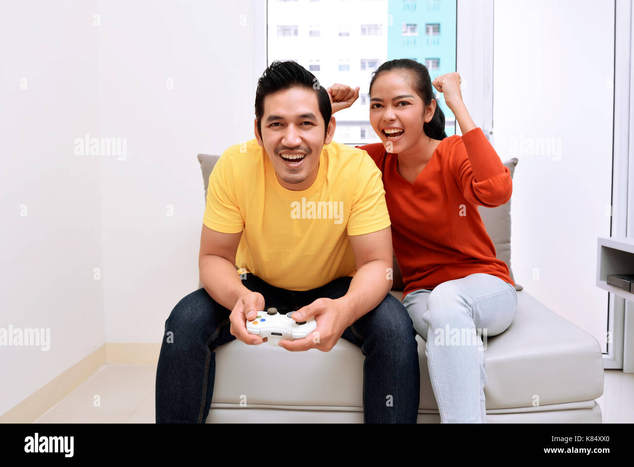 Joyful couple winning video games with joystick on console in studio.  Boyfriend and girlfriend playing online game with controller to win,  feeling happy and relaxed with leisure activity Stock Photo - Alamy