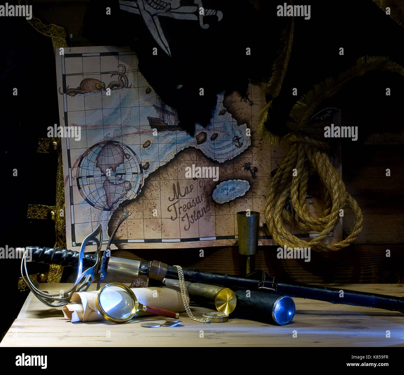 Pirate accessories and weapons laid out near the treasure map Stock