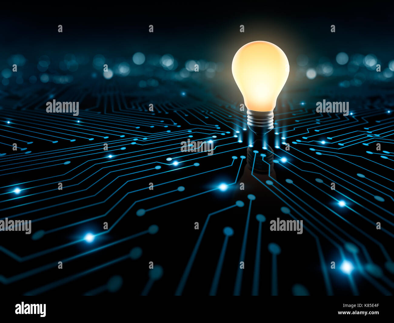 Glowing light bulb on the converging point on a circuit Stock Photo