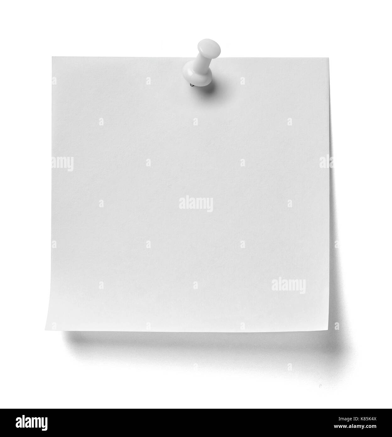close up of  a note paper with a red push pin on white background Stock Photo
