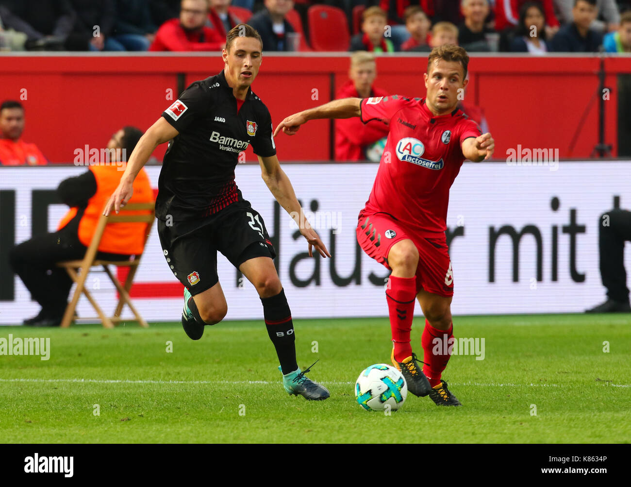 Leverkusen, Germany. 17th Sep, 2017. Leverkusen, Germany September 17, 2017, Bundesliga matchday 4, Bayer 04 Leverkusen vs SC Freiburg: Tackling Dominik Kohr (B04, L) vs Amir Abrashi (Freiburg). Credit: Juergen Schwarz/Alamy Live News Stock Photo