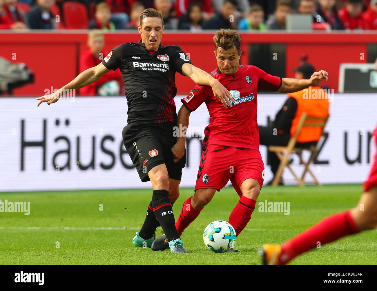 Leverkusen, Germany. 17th Sep, 2017. Leverkusen, Germany September 17, 2017, Bundesliga matchday 4, Bayer 04 Leverkusen vs SC Freiburg: Tackling Dominik Kohr (B04, L) vs Amir Abrashi (Freiburg). Credit: Juergen Schwarz/Alamy Live News Stock Photo