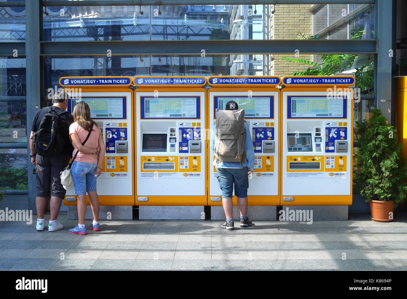 Passengers buying train tickets from self-service ticket machines, Nyugati Palyaudvar, Budapest, Hungary Stock Photo