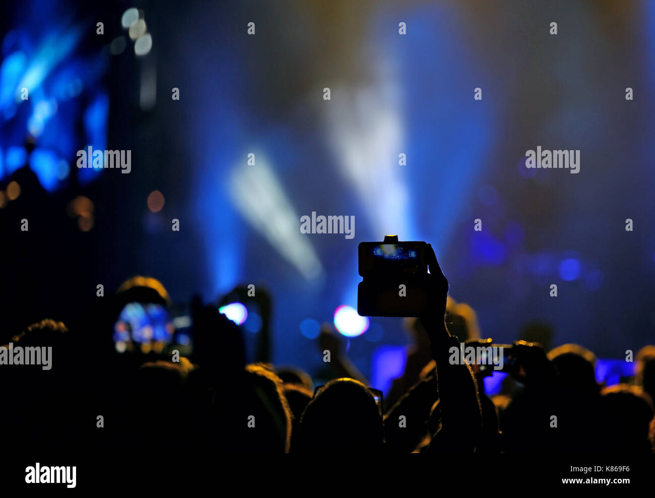 Concert Fans Camera fans who take pictures and record videos with modern smartphones during ...