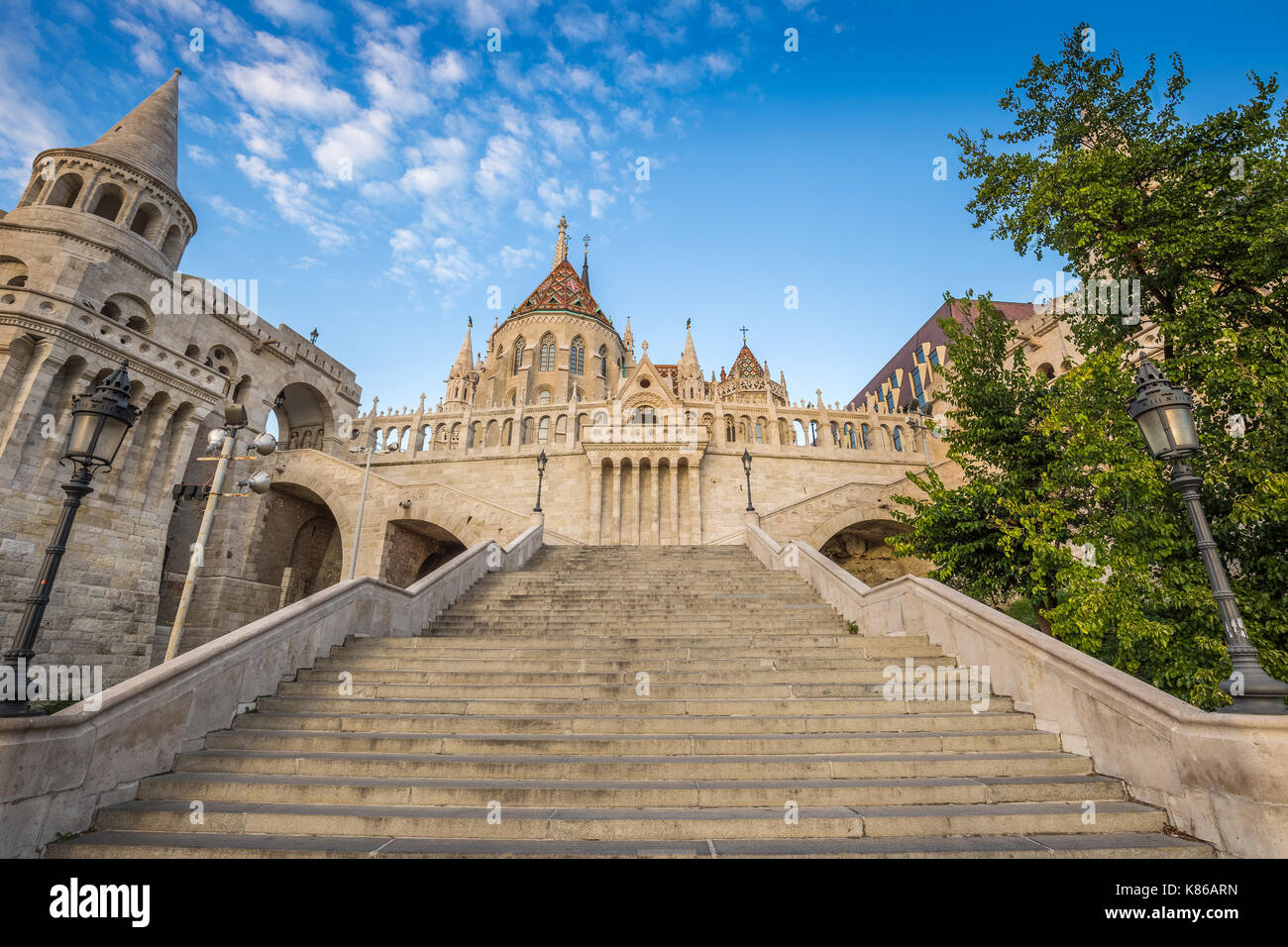 Budapest, Hungary - The beautiful stairs of the Fisherman bastion with the Matthias Church in the morning with blue sky Stock Photo