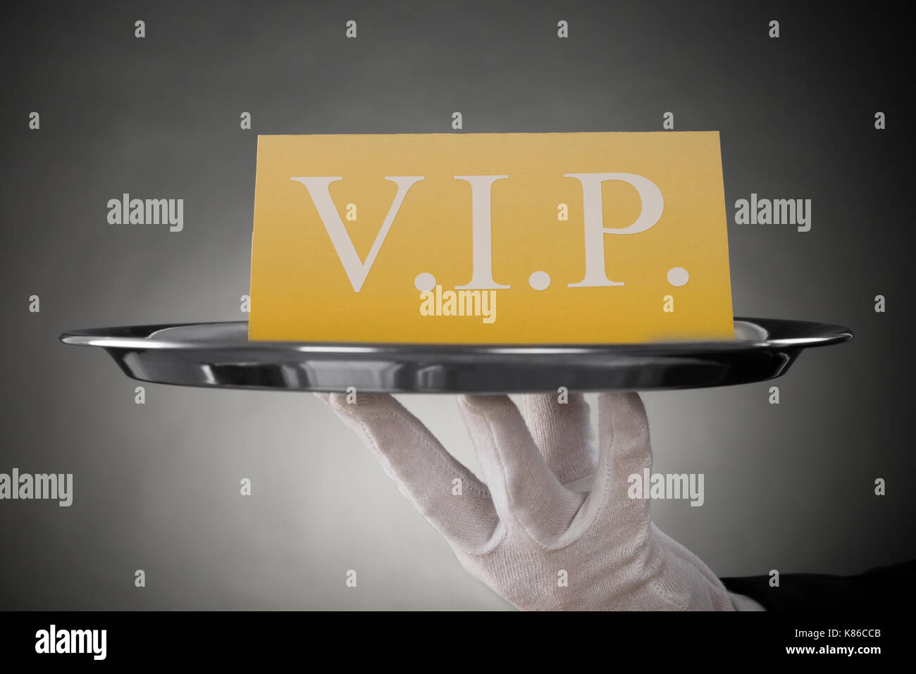 Close-up Of Waiter Showing Vip Text On Banner Stock Photo