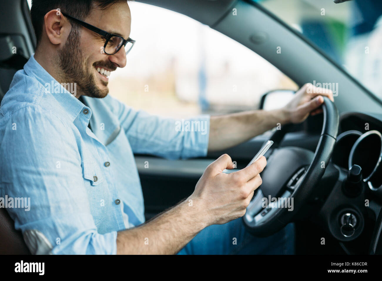 Handsome man using navigation system while driving car Stock Photo Alamy