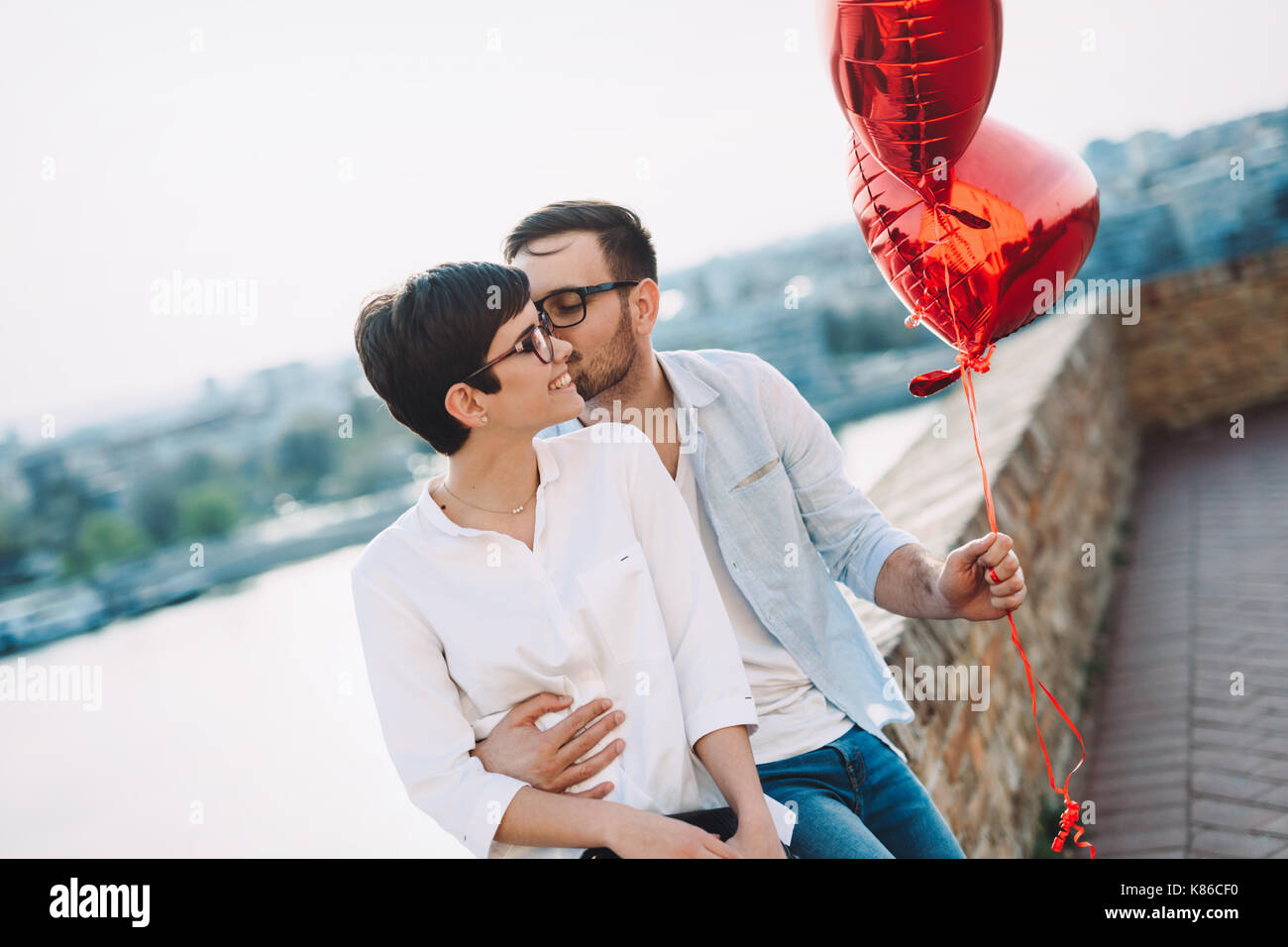 Couple in love holding red baloons hearts on valentine day Stock Photo ...
