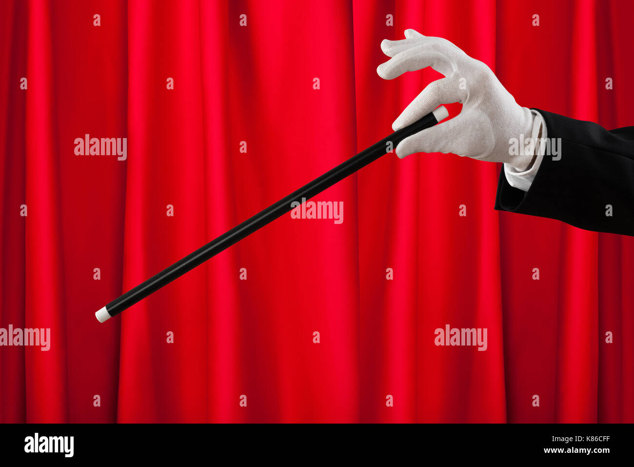 Close-up Of Magician Hands With The Magic Wand Showing Magic Stock Photo