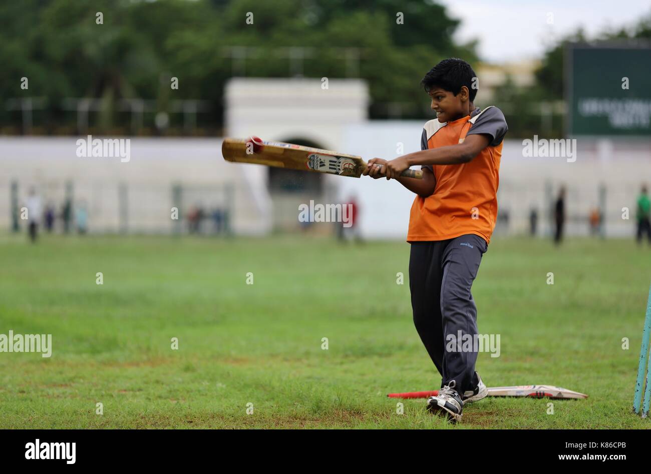 Young Sathya Sai Baba students playing cricket Stock Photo