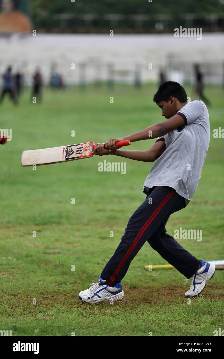 Young Sathya Sai Baba students playing cricket Stock Photo