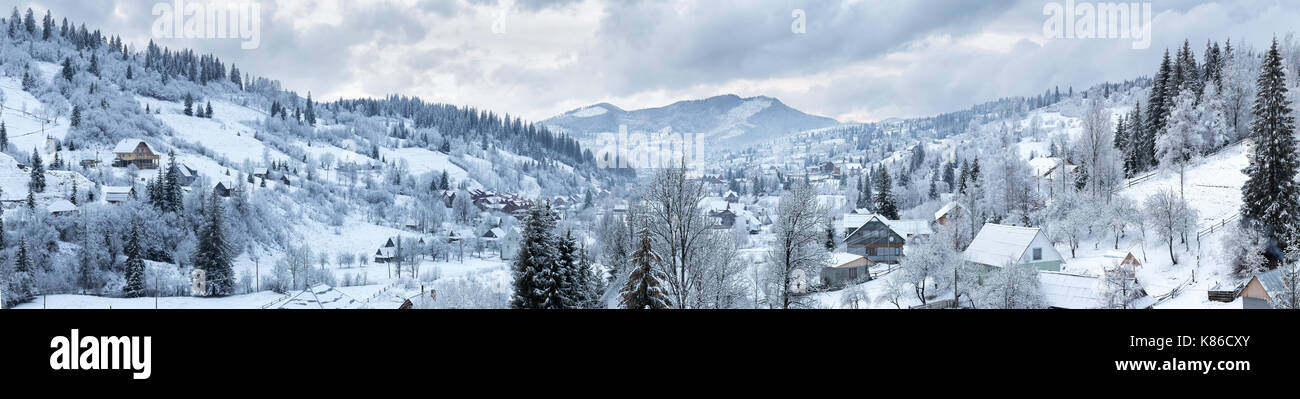 Panorama of the village in the winter mountains covered with snow ...