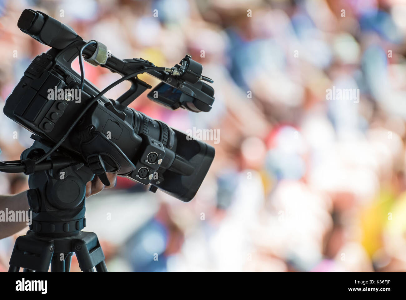 Professional TV camera making a movie of event. Stock Photo