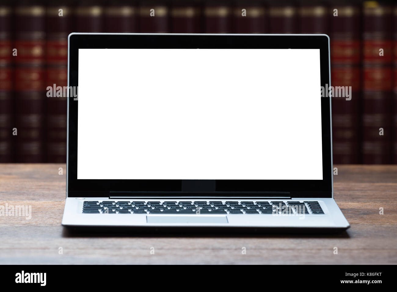 Closeup of laptop with blank screen on table in courtroom Stock Photo