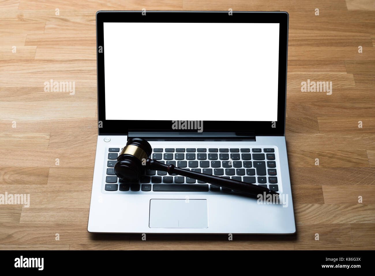 High angle view of laptop and mallet on table in courthouse Stock Photo