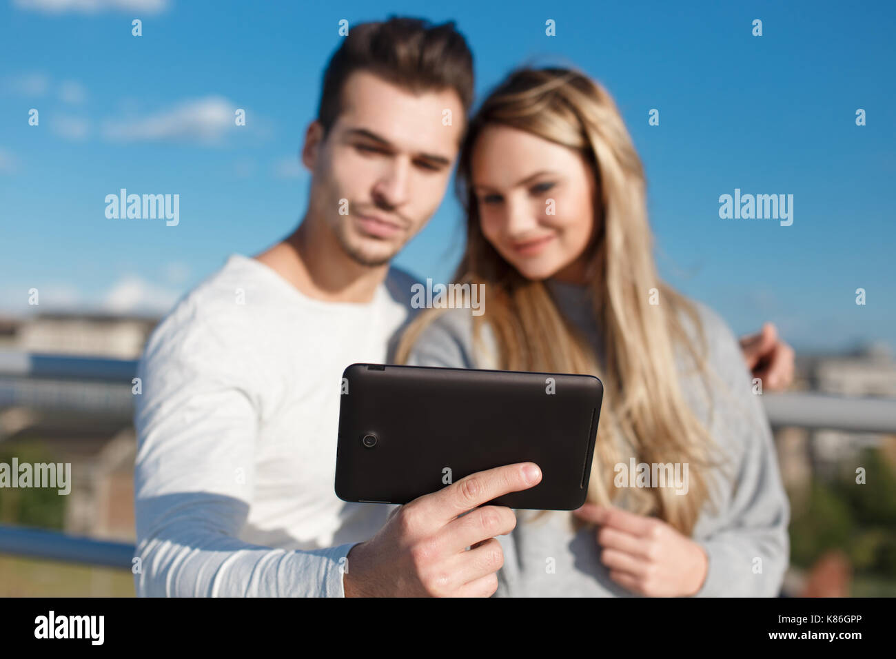 Young couple online shopping by tablet outdoor, wireless technology, depth of field Stock Photo