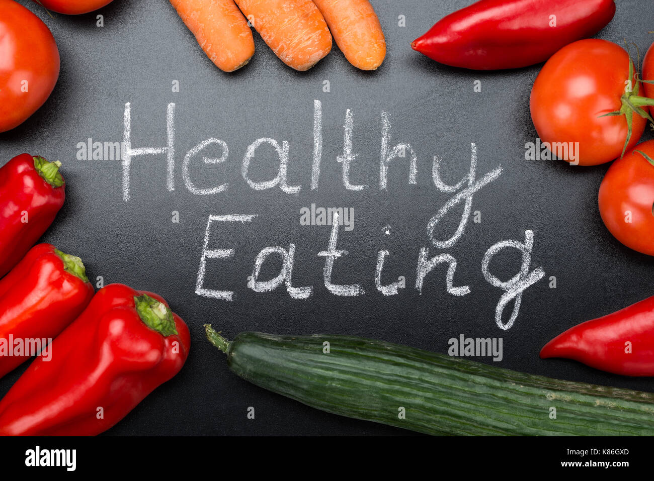 Directly above shot of Healthy Eating written amidst fresh vegetables on blackboard Stock Photo