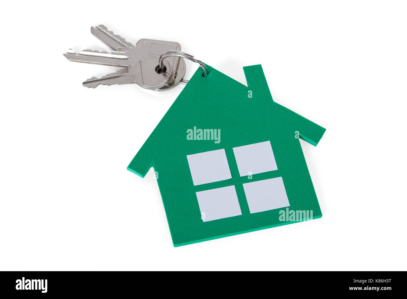 Closeup of green paper house and keys on white background Stock Photo