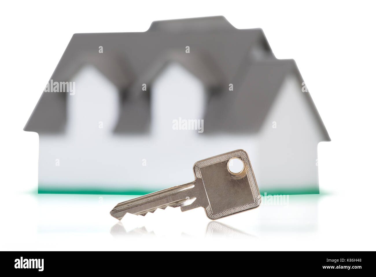 Closeup of house model and key on white background Stock Photo